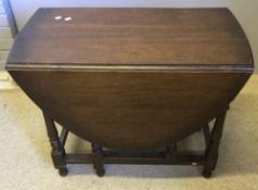 An early 20th century oak gate leg table