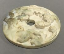 A Chinese carved hardstone roundel