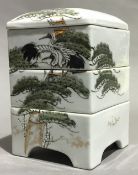 An Oriental porcelain stacking box decorated with cranes