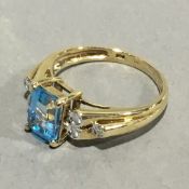 A 9 ct gold blue topaz and diamond set ring