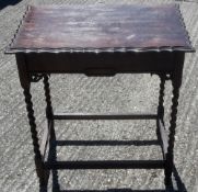 An early 20th century oak barley twist side table