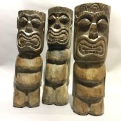 A set of three African carved wooden figures