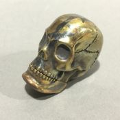 A brass vesta in the form of a skull