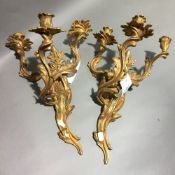 A pair of gilt bronze wall sconces