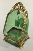 A gilt metal mounted green glass pocket watch stand