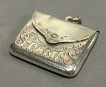 A silver stamp case,