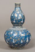 A Chinese porcelain double gourd vase Decorated with fruiting gourds interspersed with stylised