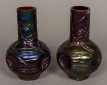 A pair of Loetz type iridescent glass vases Each with dimpled body and threaded decoration. 16.