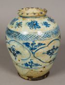 An antique Persian blue and white pottery vase Decorated with stylised floral sprays and geometric