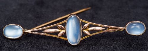 An Art Nouveau 9 ct gold moonstone set bar brooch Set with three cabochon moonstones above the