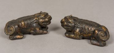 A pair of Chinese bronze scroll weights Each formed as a dog-of-fo,