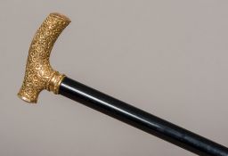 A 19th century French gold plated walking stick The floral cast handle inscribed with a name and