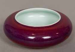 A Chinese porcelain brush washer With allover plum glaze. 11.5 cm diameter.