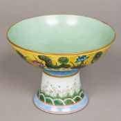A Chinese porcelain footed bowl Decorated with aquatic flora, the foot worked with stylised waves,