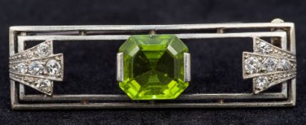 An Art Deco unmarked diamond and peridot set brooch Of rectangular form. 4 cm long.