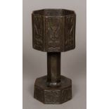 A cast metal chalice or font Of hexagonal section, worked with stylised tulips. 20.5 cm high.