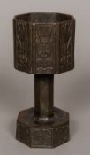 A cast metal chalice or font Of hexagonal section, worked with stylised tulips. 20.5 cm high.