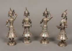 A set of four Eastern unmarked white metal figures Each wearing ornate clothing,