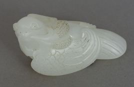 A Chinese carved white jade bird Naturalistically carved. 6 cm wide.