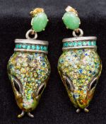 A pair of 19th century enamel decorated unmarked white metal snake heads,