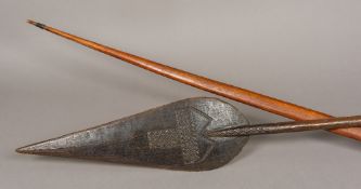 A carved wooden tribal paddle Of typical form,