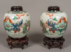 A pair of 19th century Chinese famille verte ginger jars Each decorated in the round with various