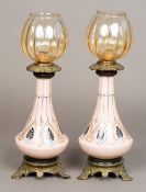 A pair of Continental gilt metal mounted porcelain table lamps Of spreading form with geometric