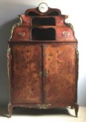 A 19th century French marquetry inlaid ormolu mounted clock cabinet The top surmounted with a