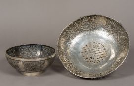 An unmarked Chinese pierced silver bowl Of low footed form decorated with dragons chasing a flaming