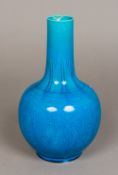 A Chinese porcelain vase Decorated with lotus strapwork on a turquoise ground. 29 cm high.