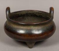 A large Chinese patinated bronze censer Of plain twin handled flattened bulbous form with three