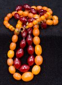 An amber bead necklace Of typical graduated form; together with a cherry amber bead necklace.