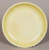 A Chinese porcelain dished plate With allover yellow/green glaze,
