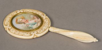 A 19th century carved ivory lady's dressing table mirror The back inset with a miniature portrait