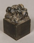 A Chinese carved soapstone seal Of square section form, the top carved with a family of goats,