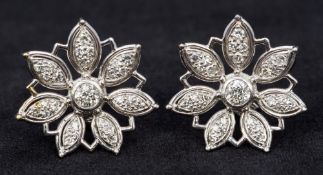 A pair of 18 ct white gold diamond set openwork earrings Each of flowerhead form.