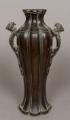 A Chinese Ming twin handled vase Of lobed baluster form, the handles dragons,