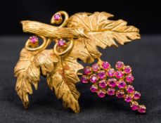 An 18 ct gold ruby set brooch Worked as a fruiting vine. 4 cm wide.