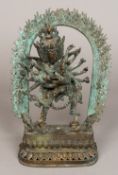 A Sino-Tibetan bronze figure of a multi-armed deity Modelled embracing another before a flaming