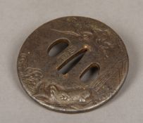 A 19th century Japanese cast iron Tsuba Decorated to one side with a carp in a river and with