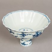 A Chinese blue and white porcelain stem cup Decorated with dragons amongst stylised clouds,