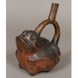 A South American Chimu pottery vessel Formed as a frog, the loop handle forming the spout.