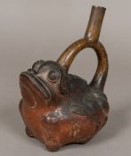 A South American Chimu pottery vessel Formed as a frog, the loop handle forming the spout.
