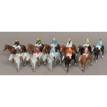 Eleven Britains Ltd painted lead horses and jockeys Painted in various owners' colours. 10 cm high.