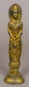 A Chinese gilt bronze figure of Guanyin Modelled standing above a temple lion. 31 cm high.