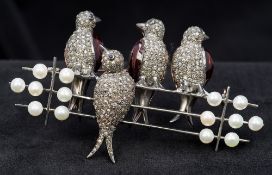 An unmarked diamond and pearl set bar brooch Formed as four birds perched on a telegraph wire.