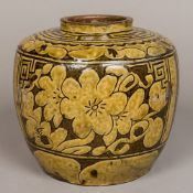 A Chinese pottery jar With incised floral decoration. 21.5 cm high.