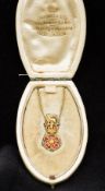 An Edwardian enamel decorated unmarked gold Regimental pendant on chain Formed as the crest of the