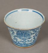 A Chinese blue and white porcelain tea bowl Decorated with stylised bats and calligraphic roundels,