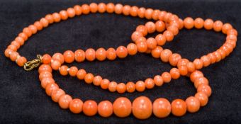 A coral bead necklace Of single strand graduated form. 51 cm long.